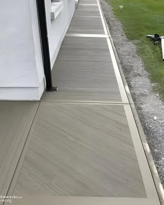 Finished concrete walkway beside a building service card