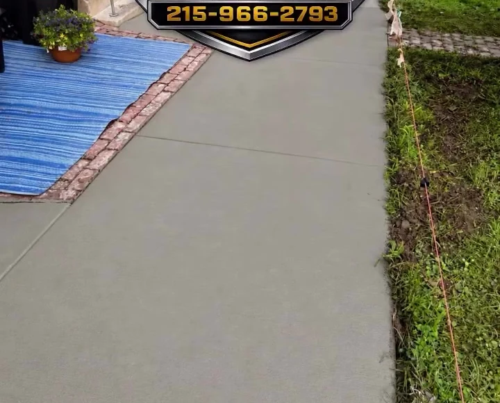 Fresh concrete walkway with Raider branding from a July project video